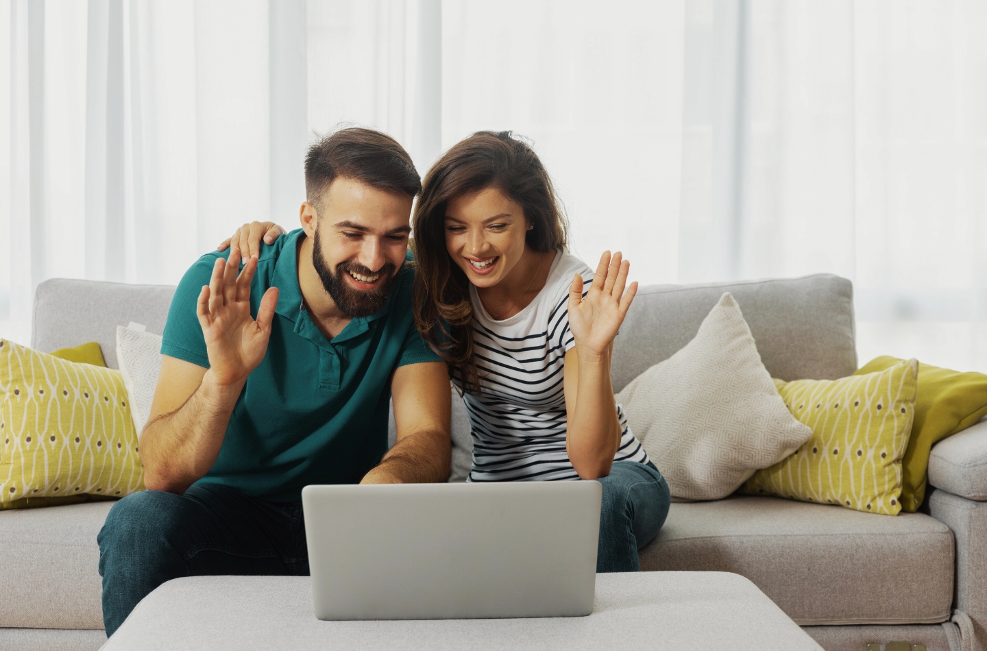 Couple waving at laptop screen during psychotherapy session